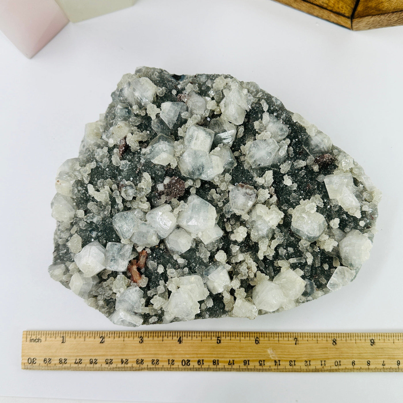 zeolite on matrix next to a ruler for size reference