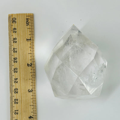 crystal quartz faceted egg next to a ruler for size reference