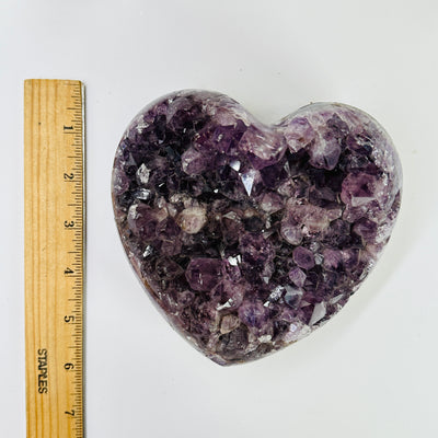 amethyst heart next to a ruler for size reference