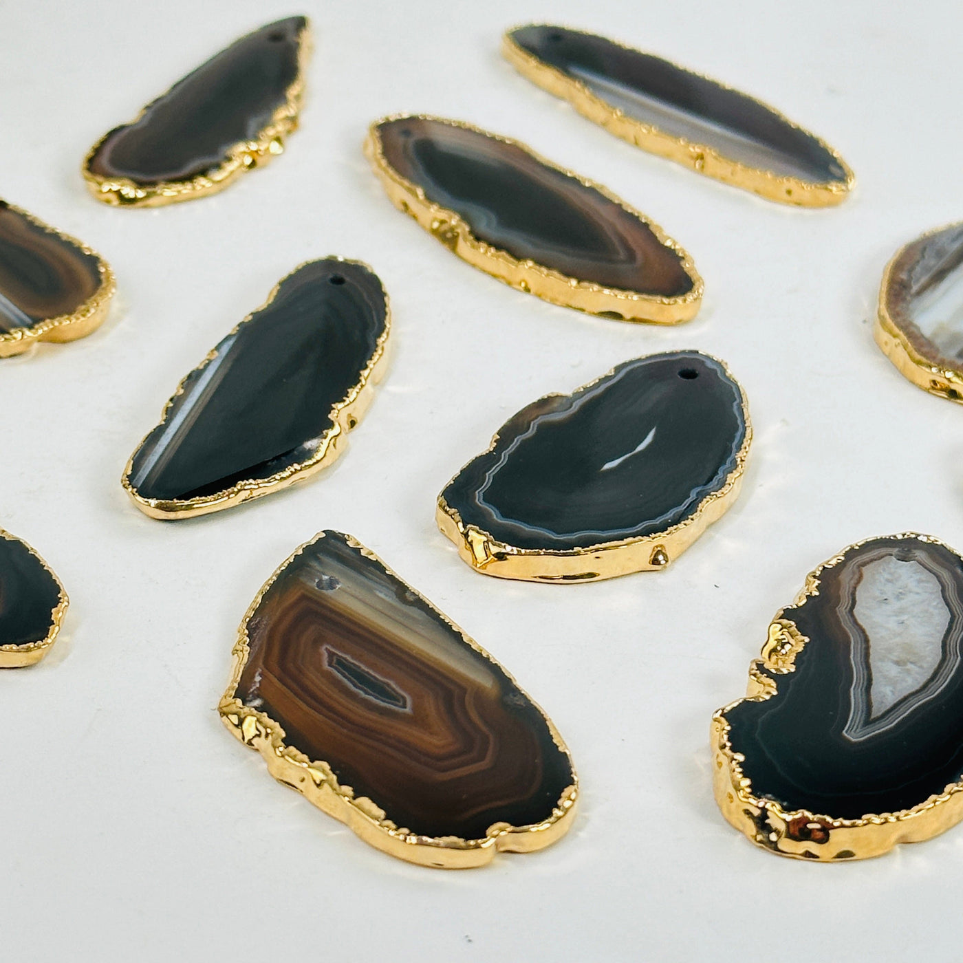 angled shot of brown agate slice beads on white background