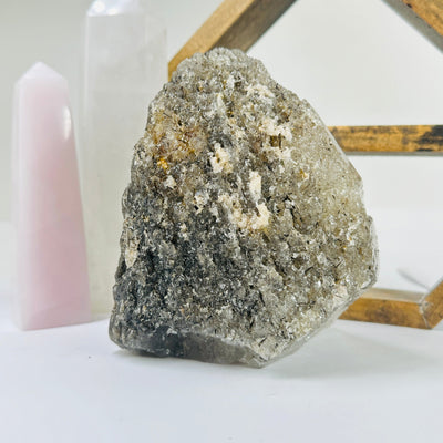 rutilated quartz with decorations in the background