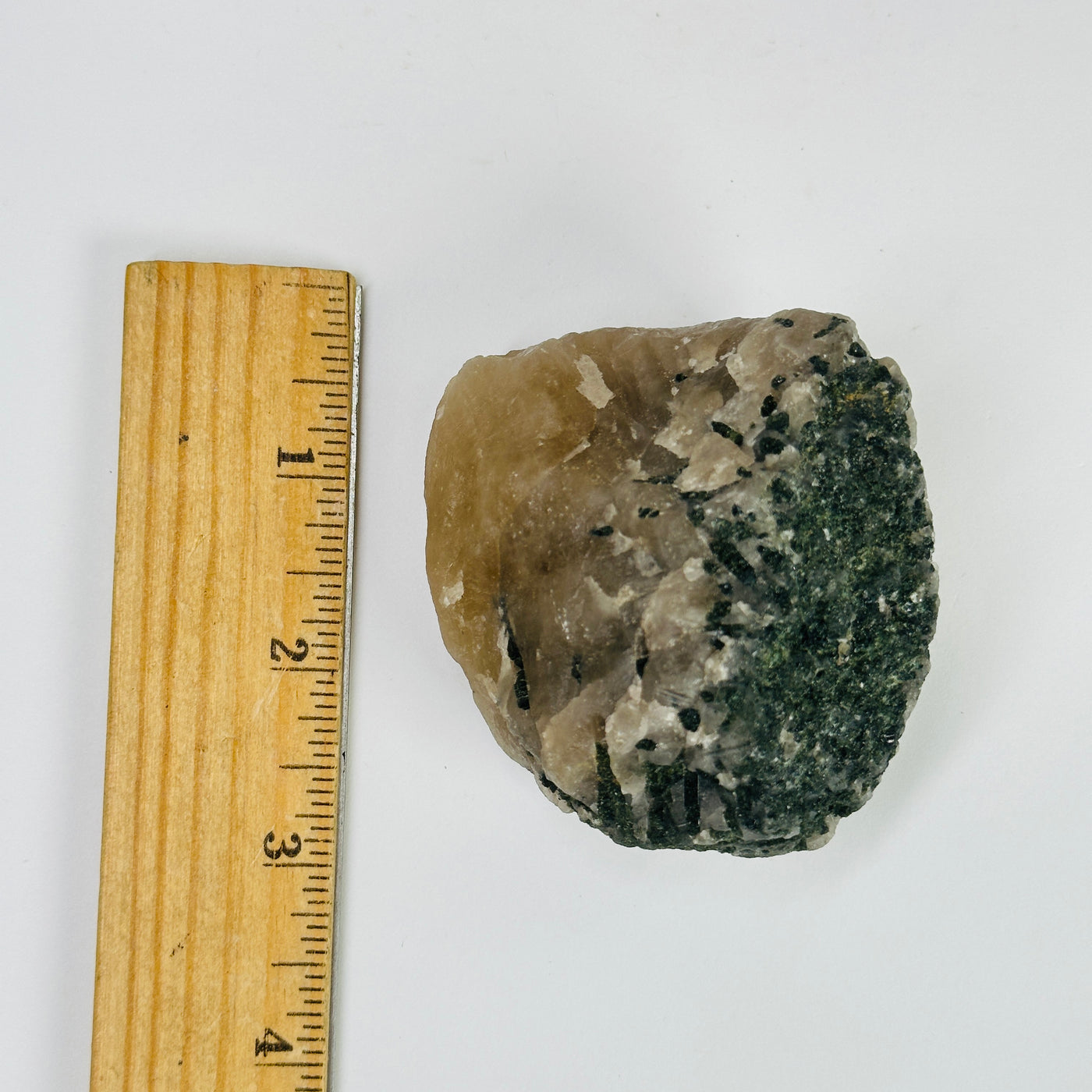 tourmaline next to a ruler for size reference