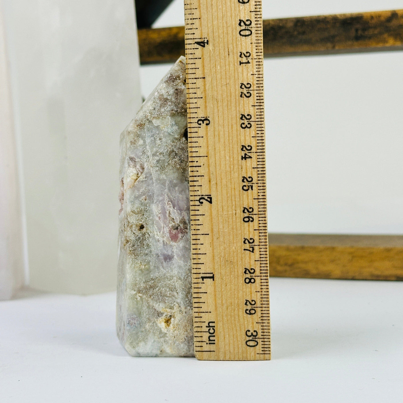 tourmaline point next to a ruler for size reference