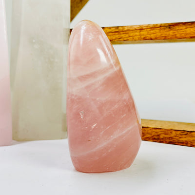 rose quartz cut base with decorations in the background