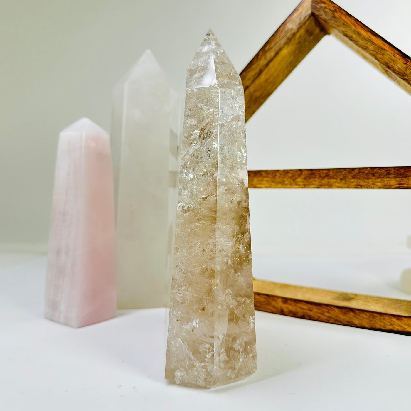 crystal quartz point with decorations in the background