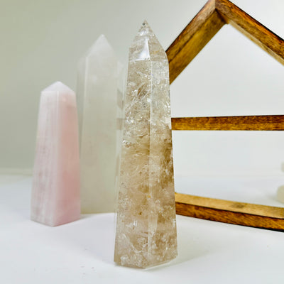 crystal quartz point with decorations in the background