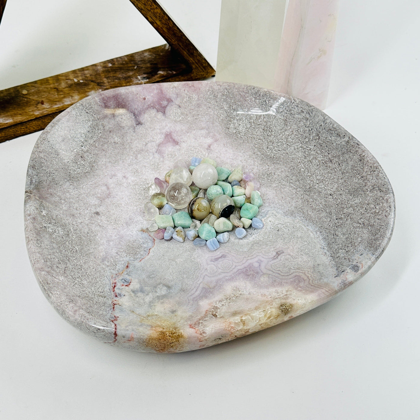 pink amethyst plate with decorations in the background and inside it