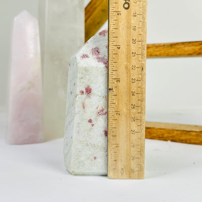 tourmaline point next to a ruler for size reference