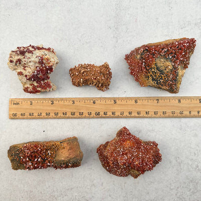 Raw Vanadinite Specimen next to a ruler for size reference 