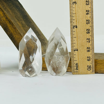 crystal quartz point with decorations in the background