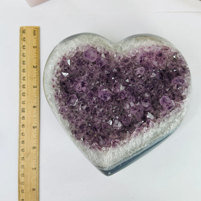 amethyst heart next to a ruler for size reference