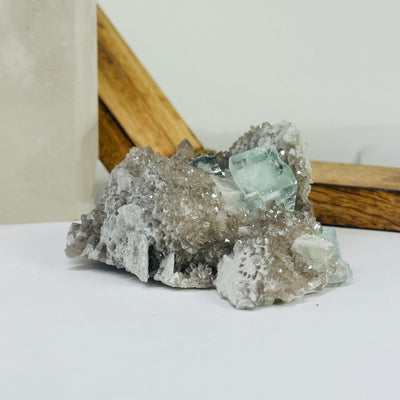 Blue fluorite crystal with decorations in the background