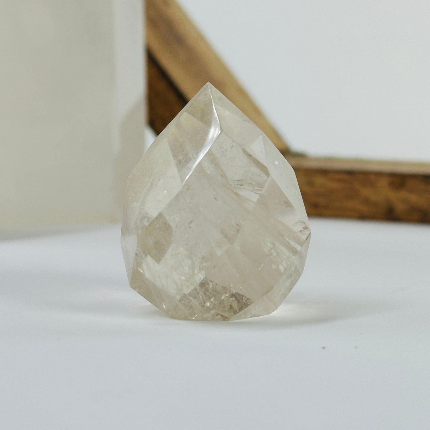 citrine faceted point with decorations in the background