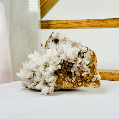 calcite on matrix with decorations in the background