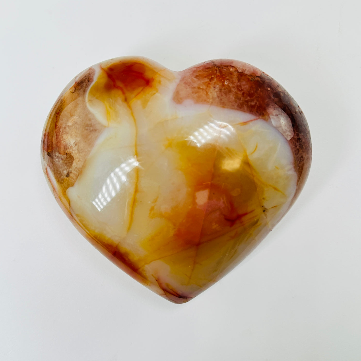 carnelian heart with decorations in the background