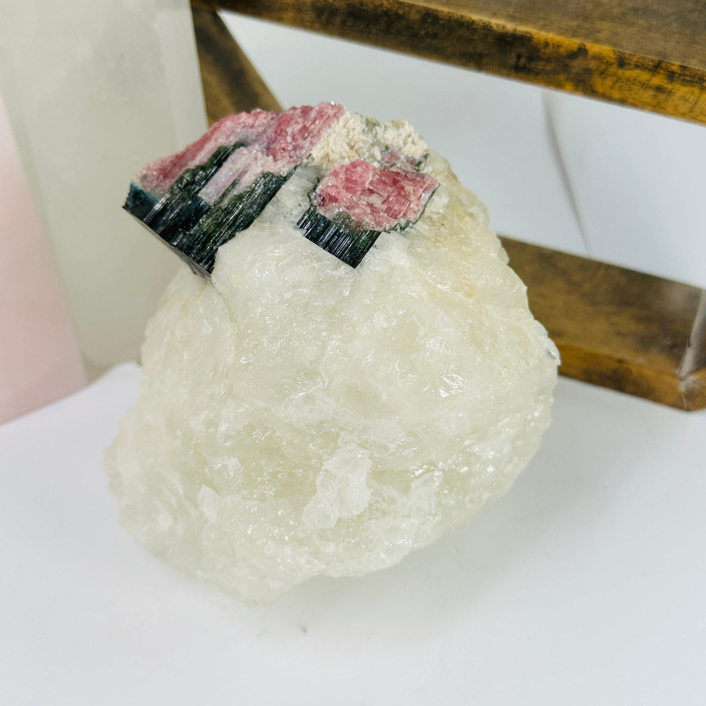 watermelon tourmaline with decorations in the background