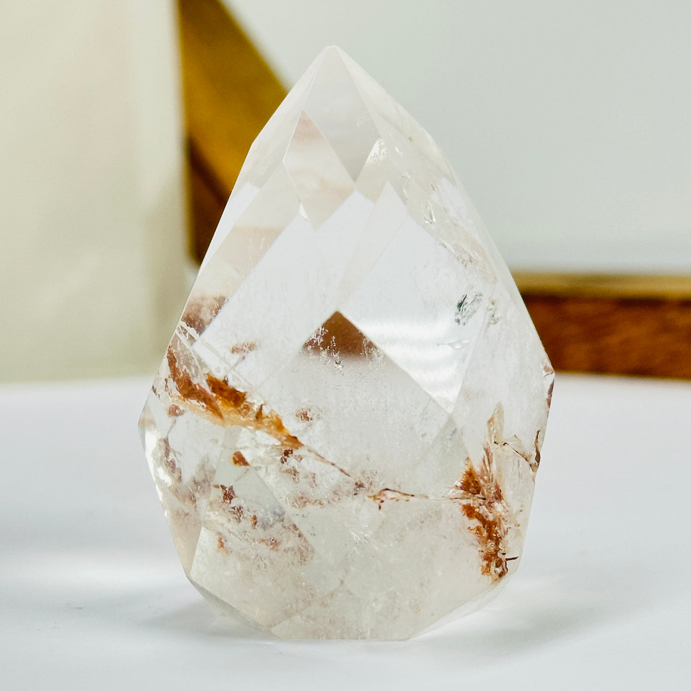 crystal quartz point with decorations in the background