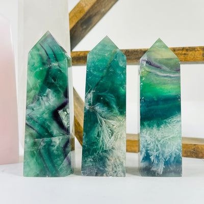 fluorite point with decorations in the background