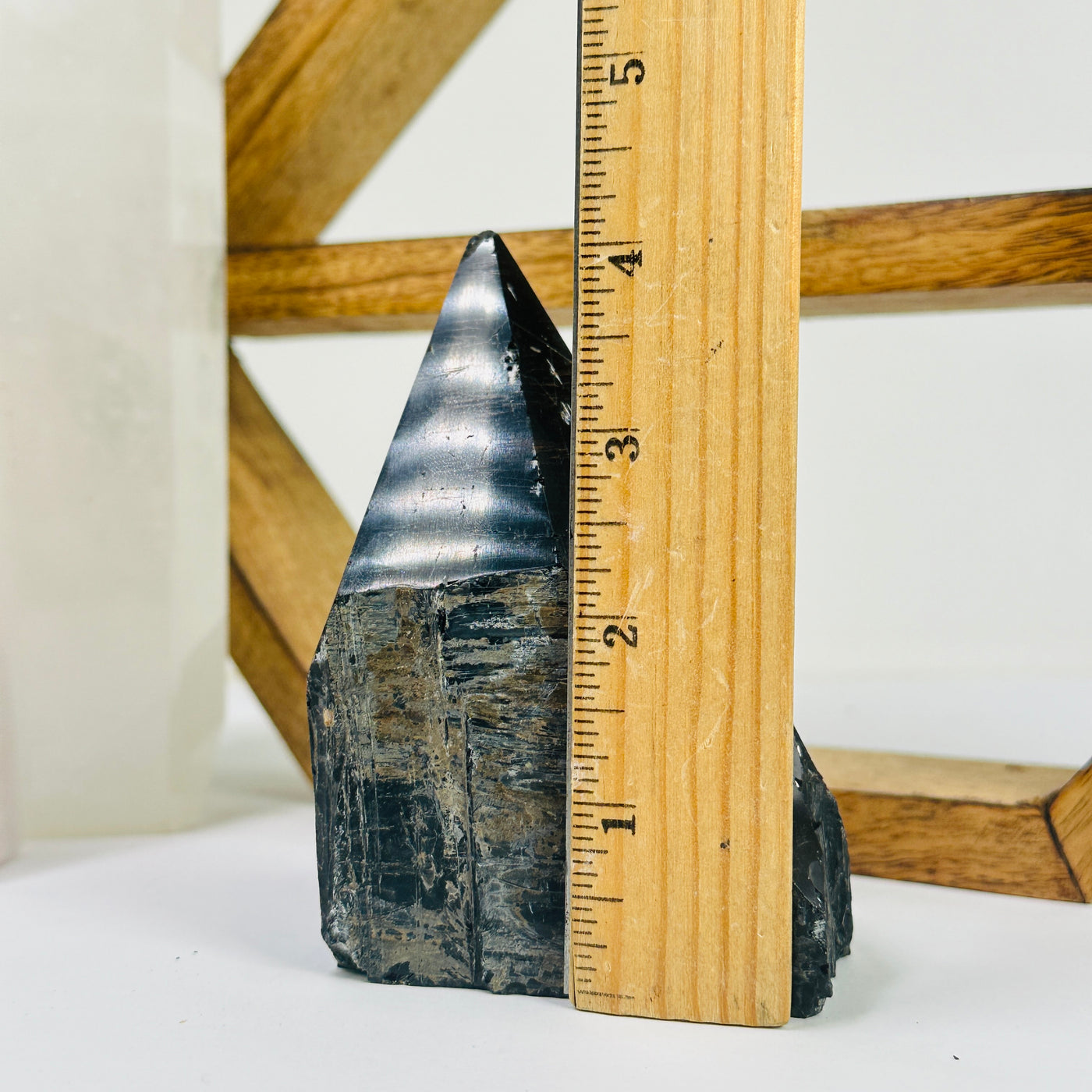 tourmaline point next to a ruler for size reference