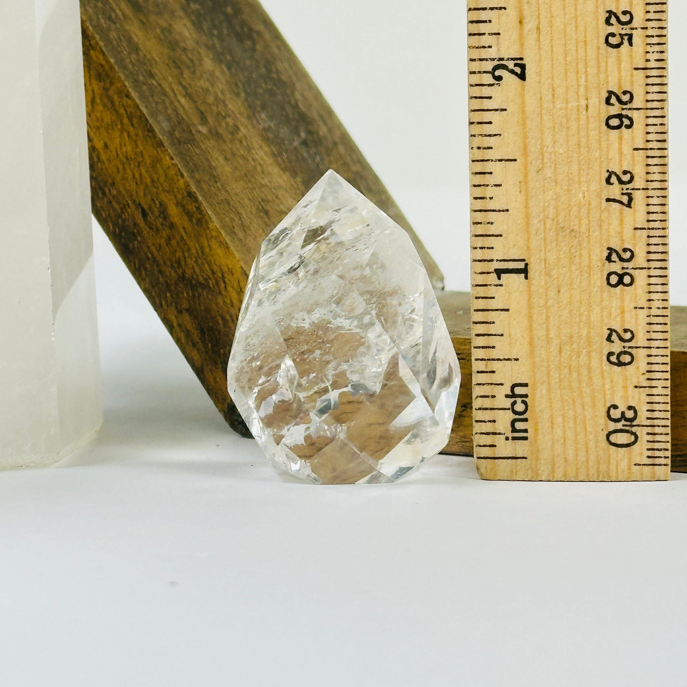 crystal quartz point with decorations in the background