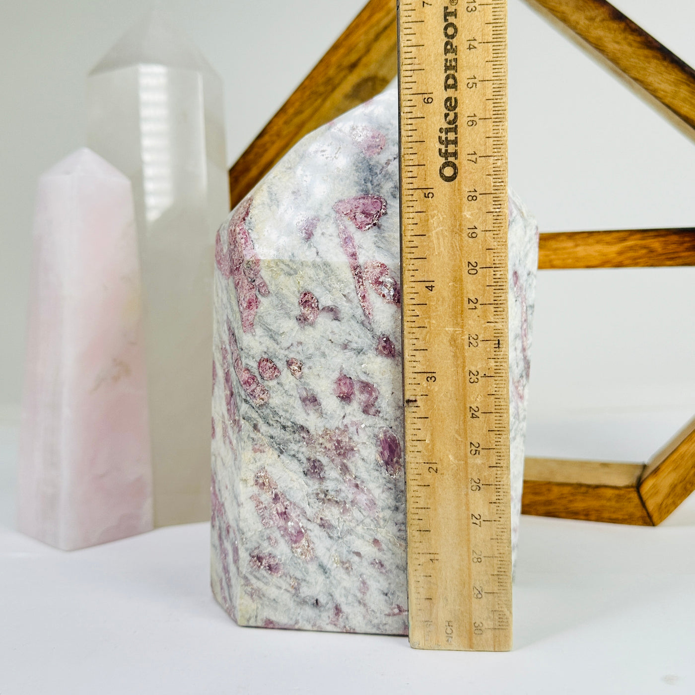 tourmaline point next to a ruler for size reference