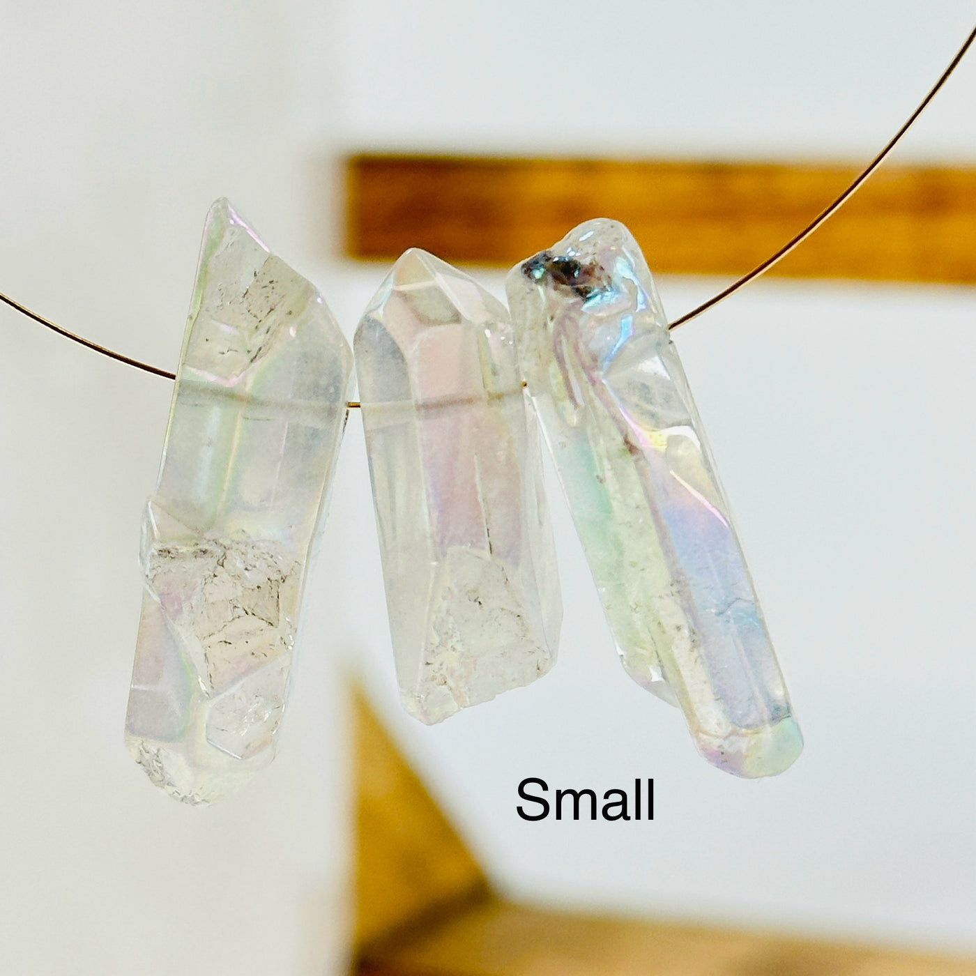 aura quartz crystal with decorations in the background