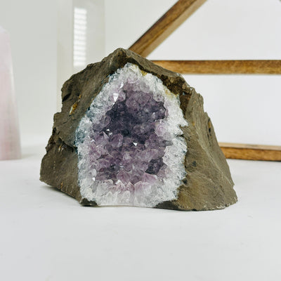 amethyst on matrix with decorations in the background