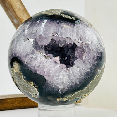 amethyst sphere with decorations in the background