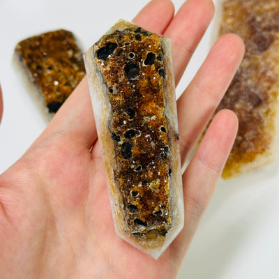 citrine double terminated point with decorations in the background