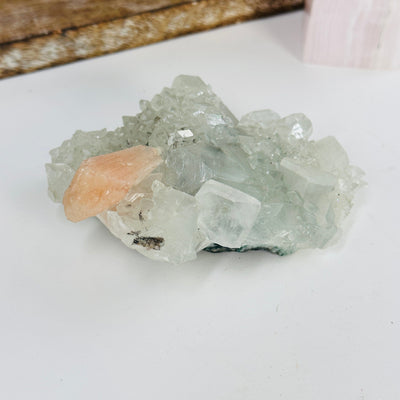 peach apophyllite with Stilbite with decorations in the background