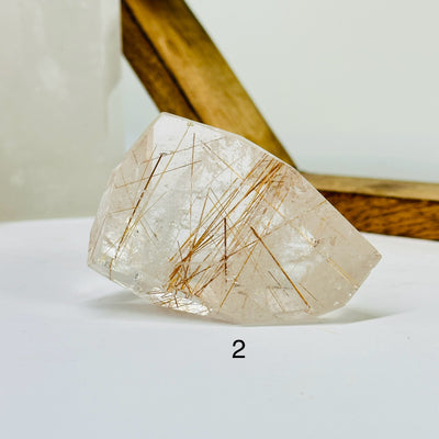 rutile quartz with decorations in the background