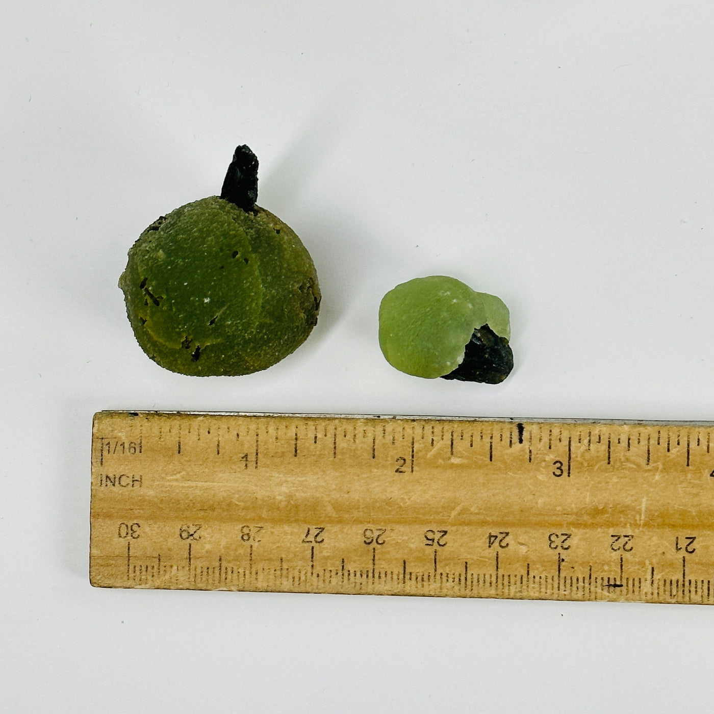 2 episode with prehnite cluster next to a ruler for size reference