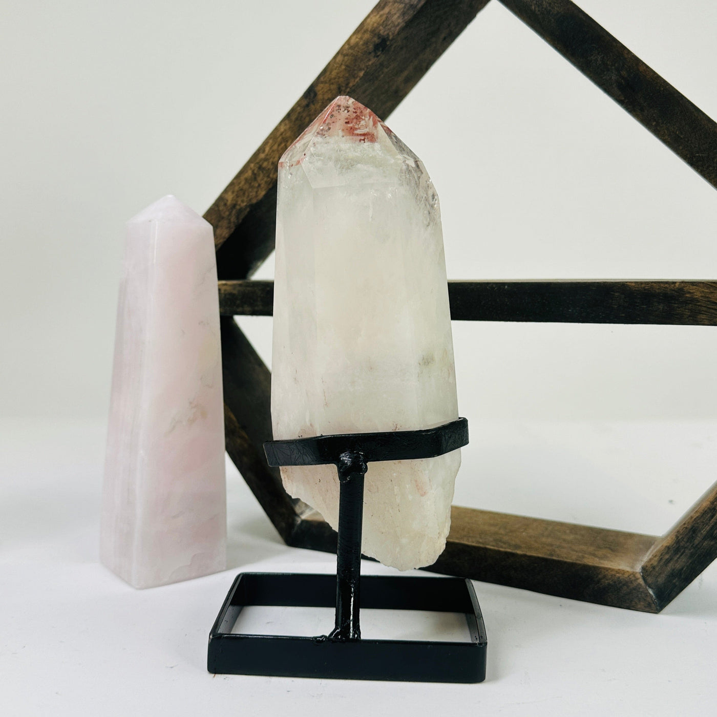 crystal quartz on metal stand with decorations in the background