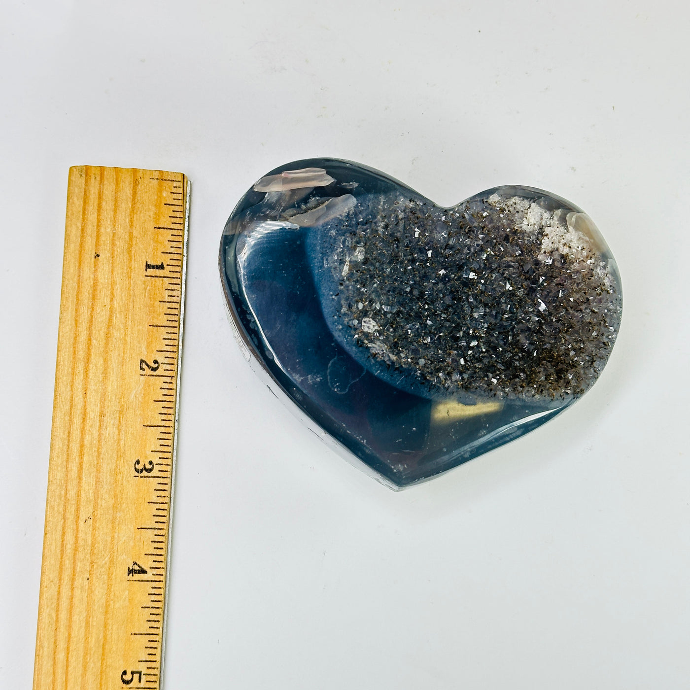 agate heart next to a ruler for size reference