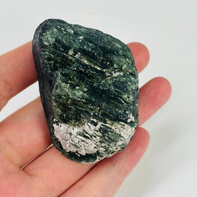 green and black tourmaline with decorations in the background