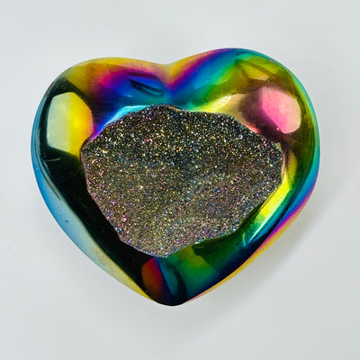 titanium coated heart with decorations in the background