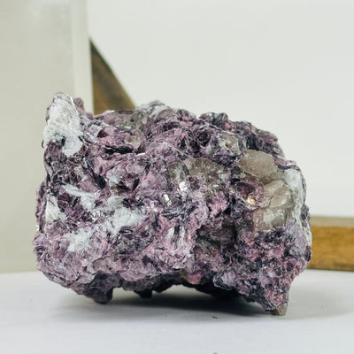 lepidolite cluster with decorations in the background