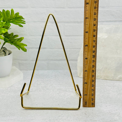 Crystal Slice Holder- Slab Stand of Brass next to a ruler for size reference 