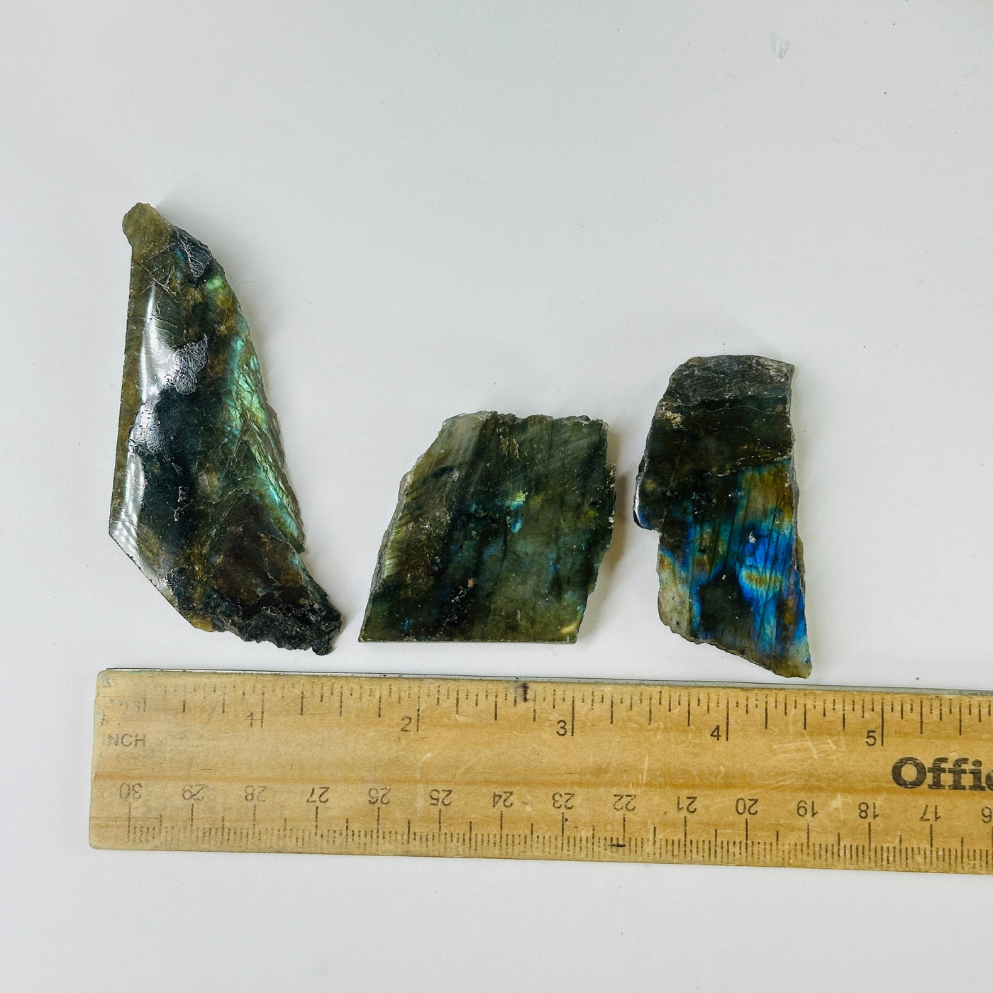 labradorite slab next to a ruler for size reference