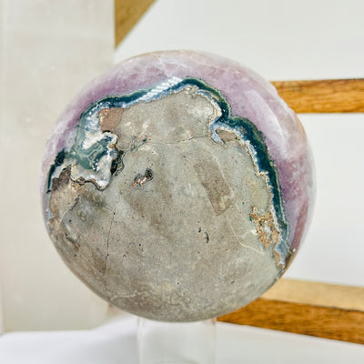 amethyst sphere with decorations in the background