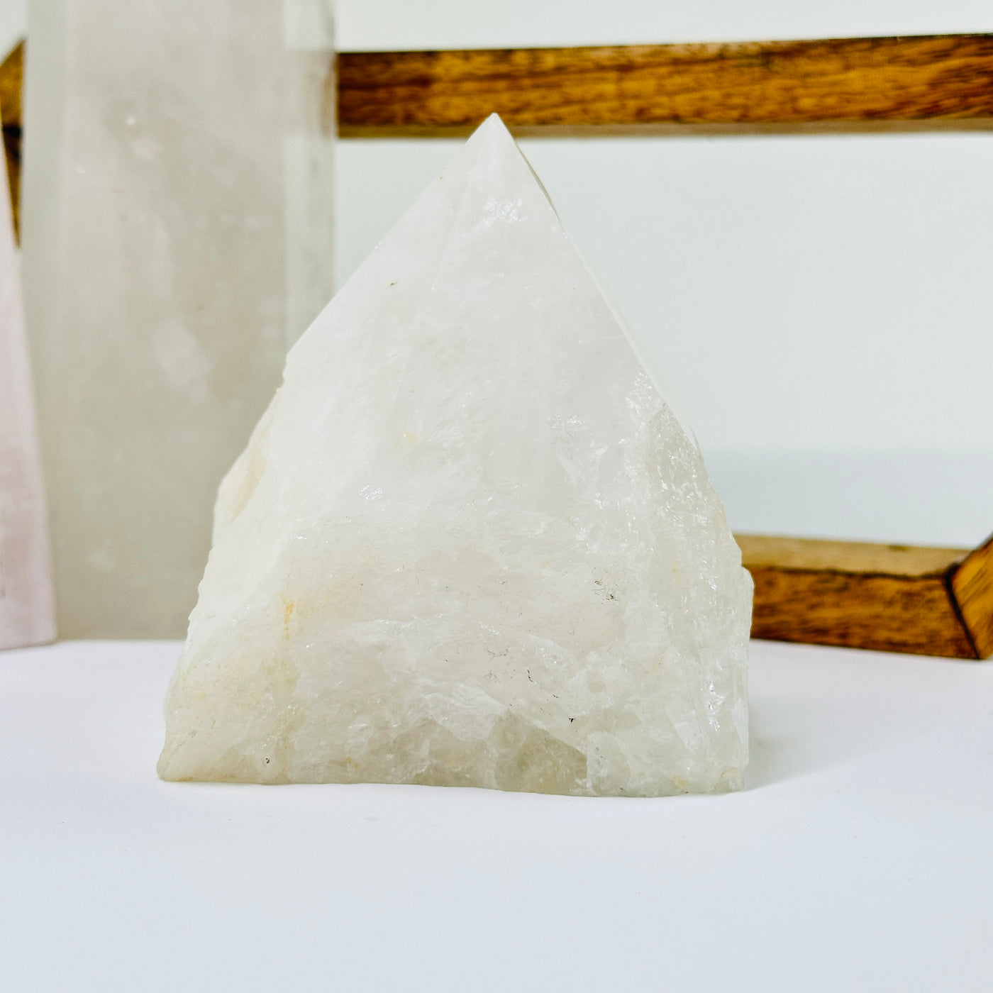 crystal quartz point with decorations in the background