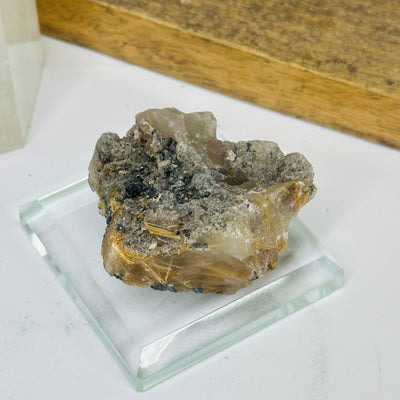 rutilated quartz with decorations in the background