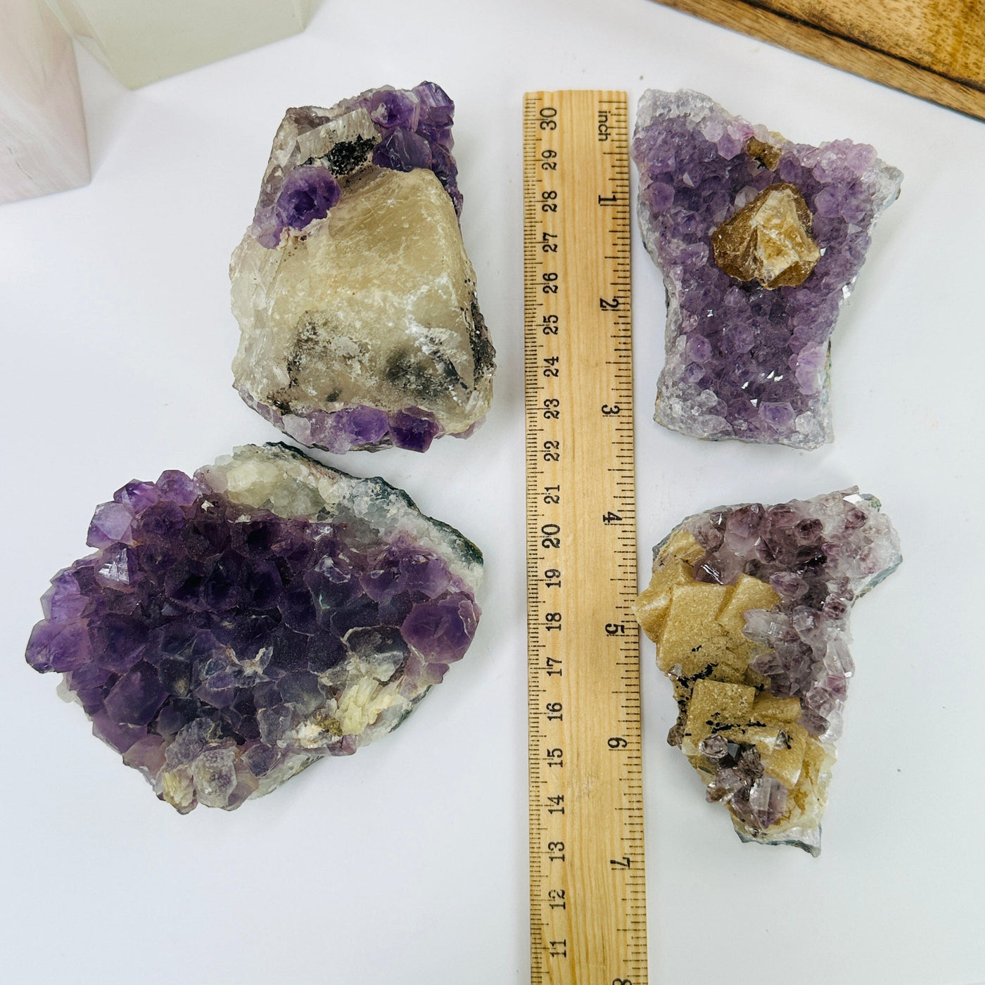 amethyst cluster next to a ruler for size reference