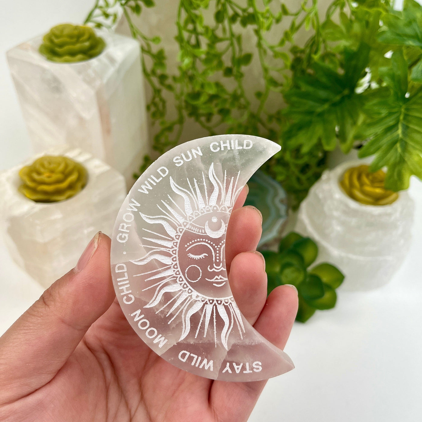 Selenite Moon Engraved Charging Plate - Sun and Moon Design - in hand for size reference with props in background