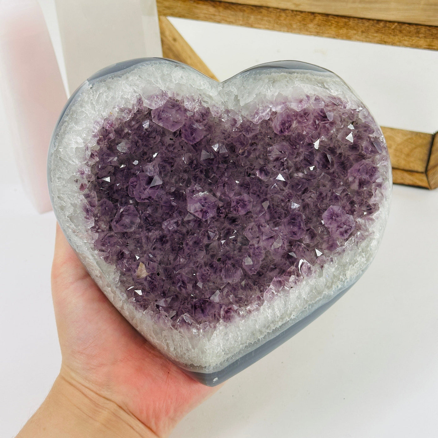 amethyst heart with decorations in the background