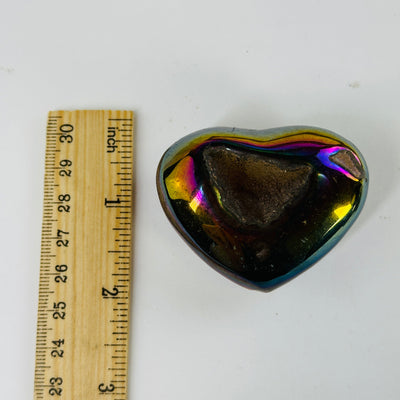 aura agate hearts next to a ruler for size reference