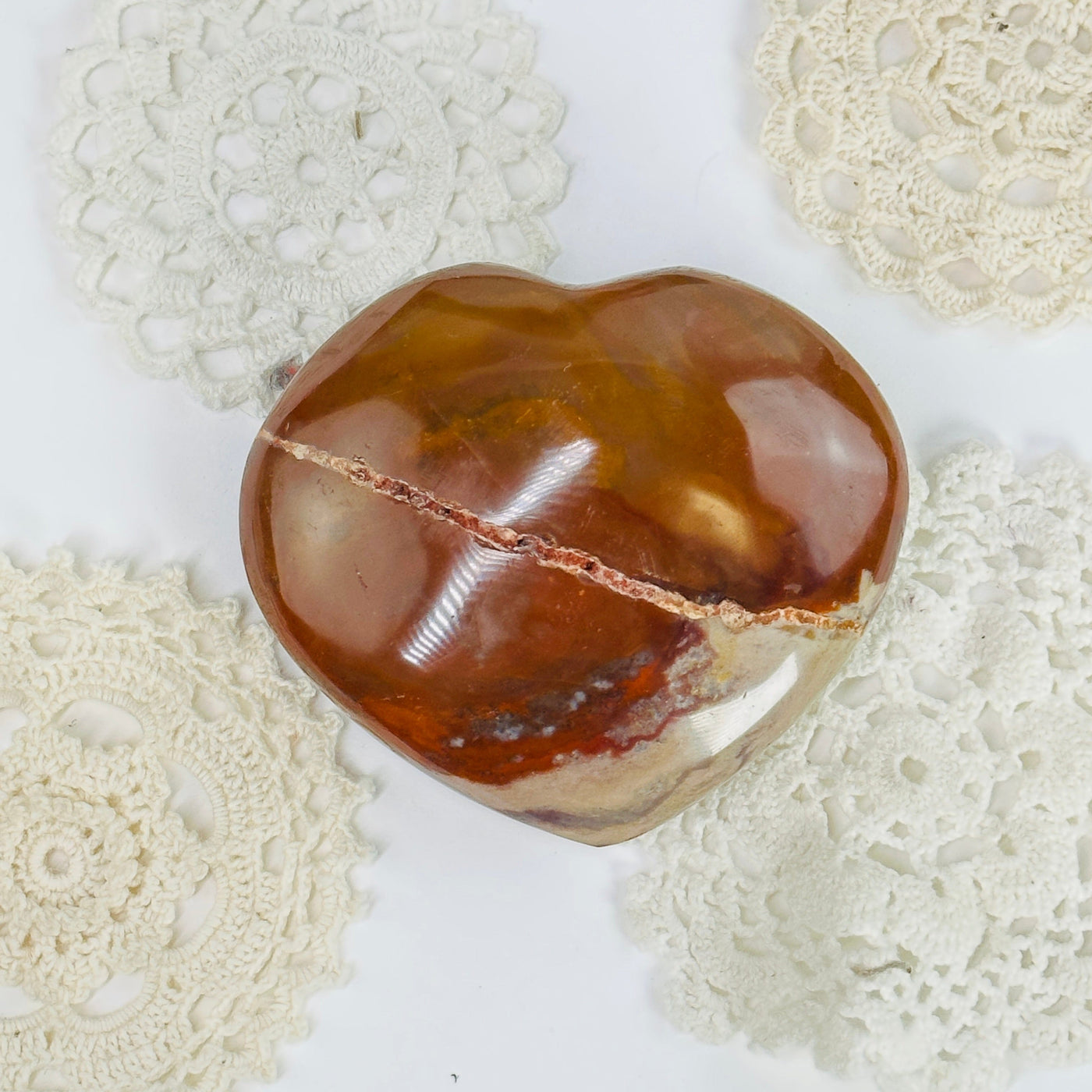 carnelian heart with decorations in the background