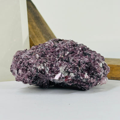 lepidolite cluster with decorations in the background