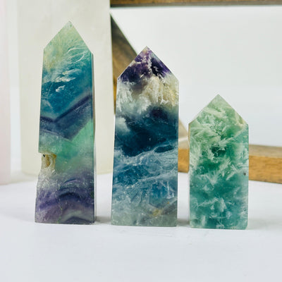 fluorite point with decorations in the background