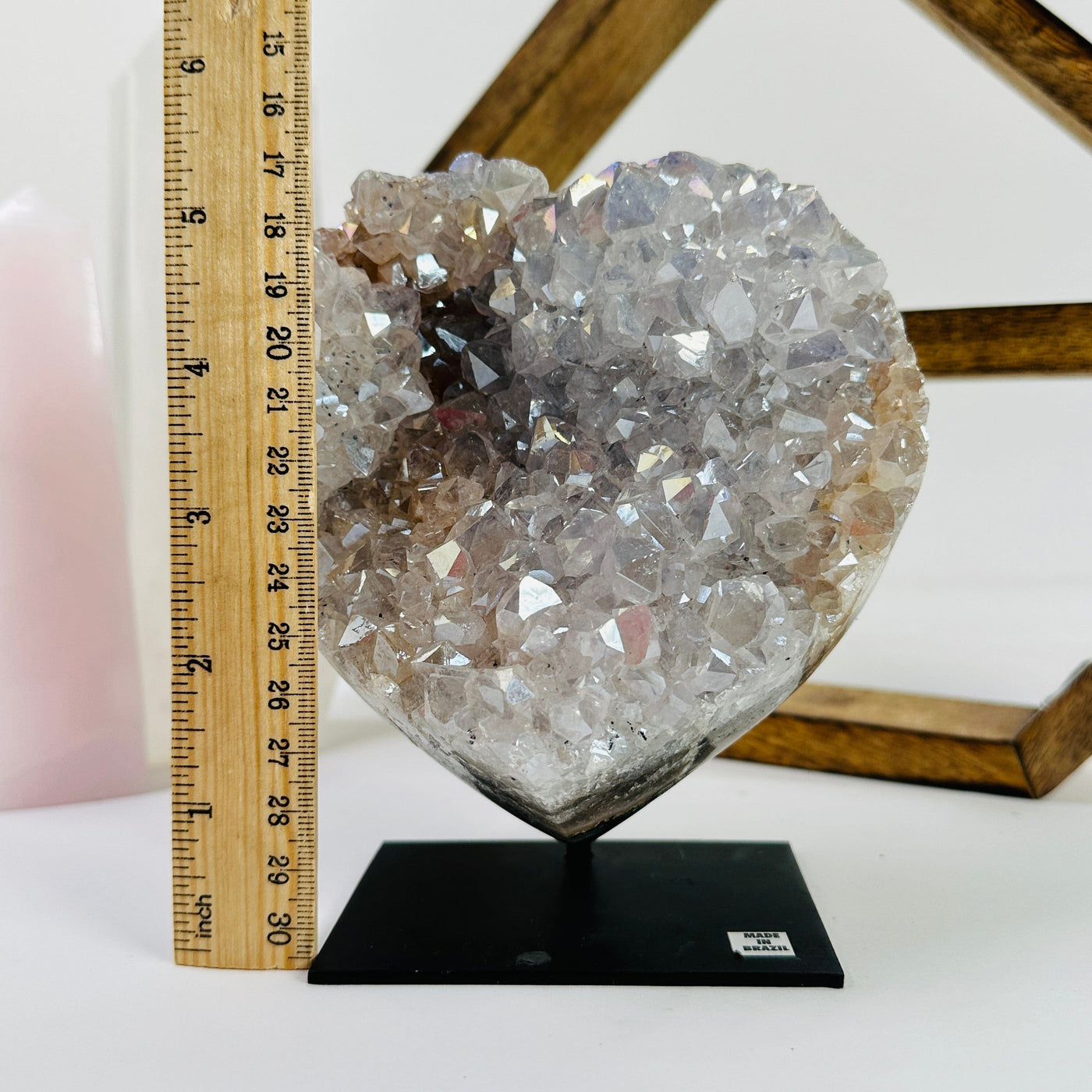 angle aura amethyst heart on stand next to a ruler for size reference